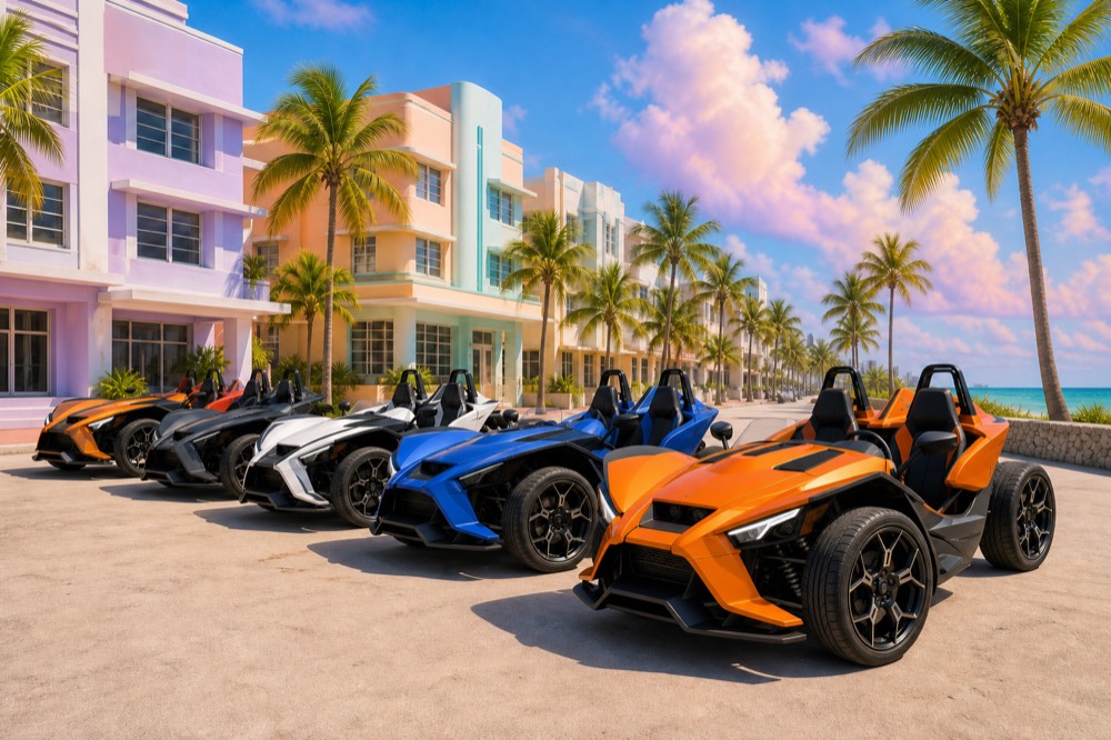 A row of Polaris Slingshots parked along a Miami Beach street