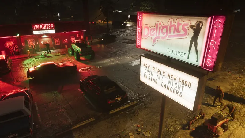 The outside parking lot of a club in Port Gellhorn at night with signs lit up advertising the cabaret. Several cars are parked, a few people linger outside of the club, and two people walk under the sign, one pushing a shopping cart.