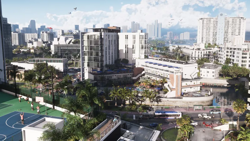 A view of Vice City with roads, palm trees, a basketball court, and more buildings in the background.