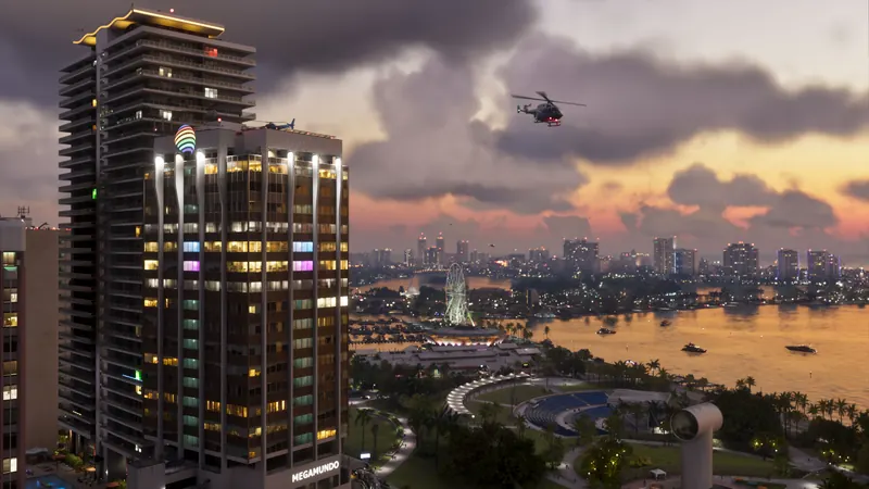 Sunset from a high-rise over a bayfront park with a Ferris wheel, helicopter overhead and the bay beyond.